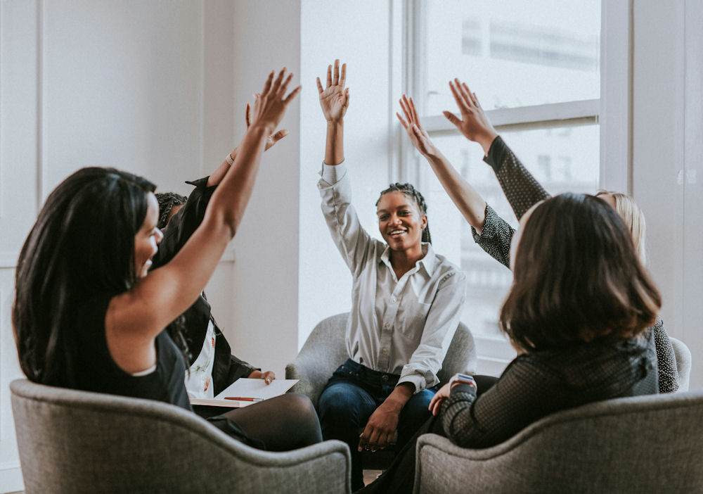 women-raising-hands-in-therapy