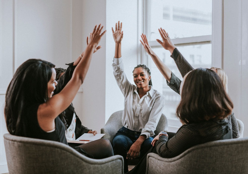 a-group-of-women-holdings-hands-up-in-therapy