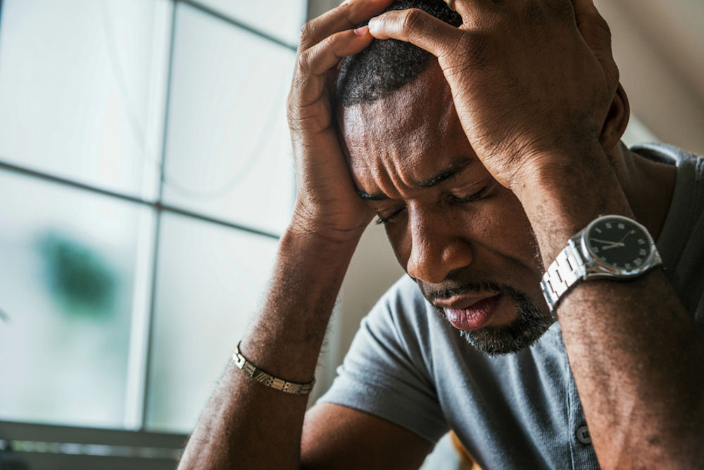 man-with-hands-on-head-dealing-with-depression