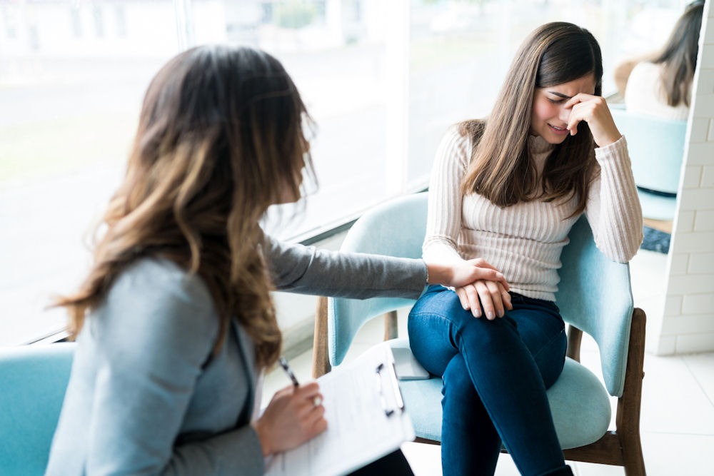 woman-being-consoled-in-therapy