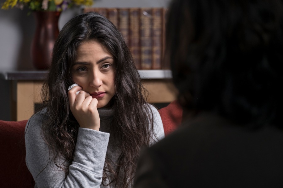 A woman with her hand on her face depressed