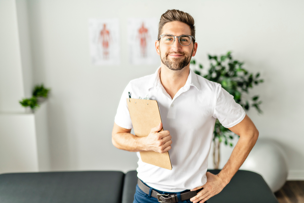 male therapist or mental health counselor smiling