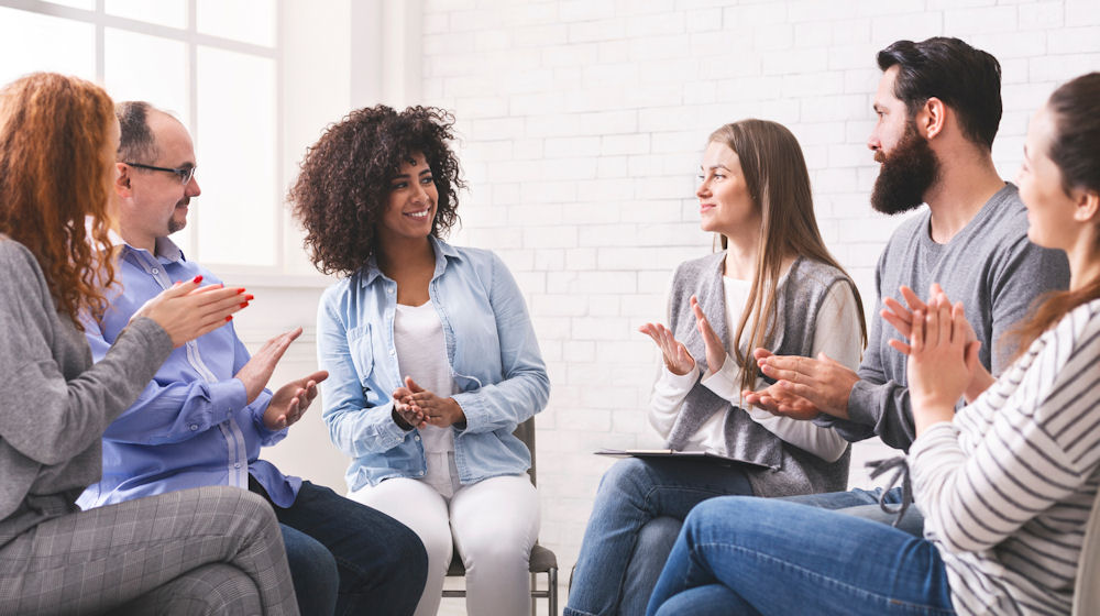 people clapping during a group therapy session