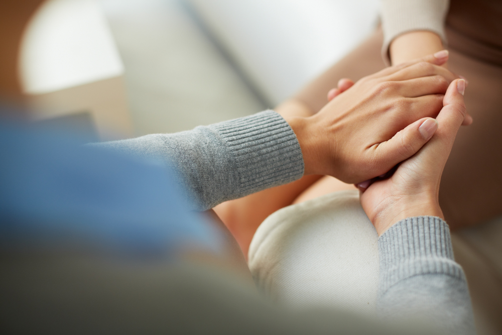 holding hands in support