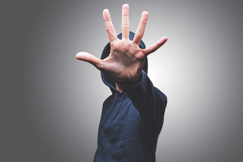 a man holding up 5 fingers representing the five criteria for involuntary admission in NJ
