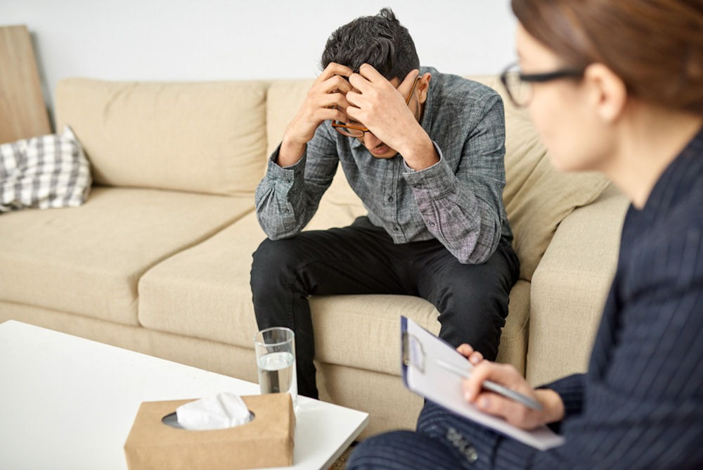 a man being evaluated by a therapist