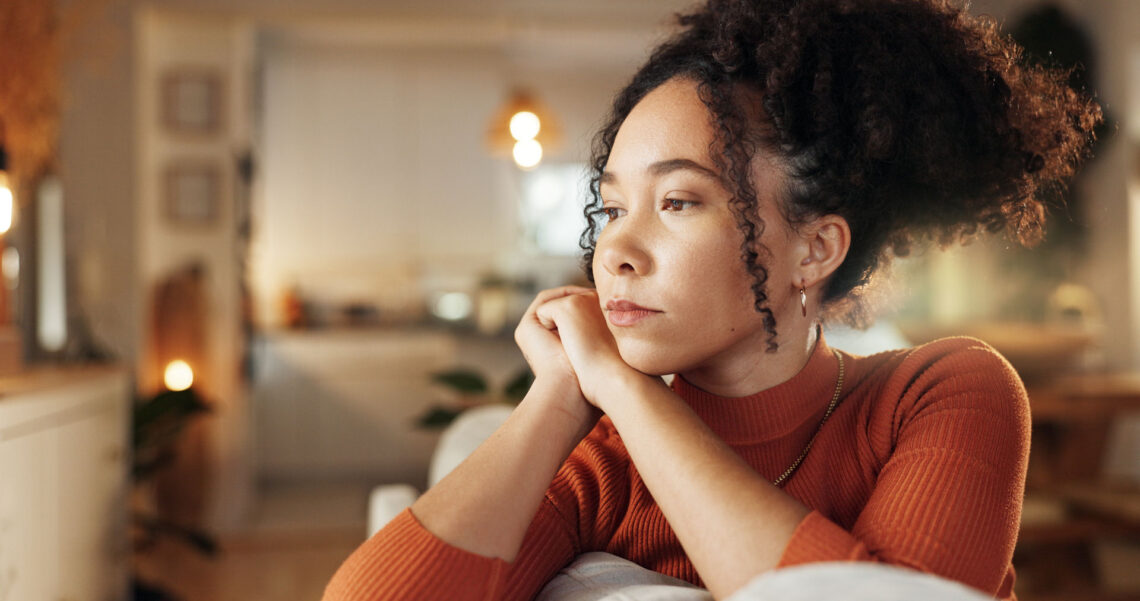 Young adult sitting alone and feeling anxious about their relationship