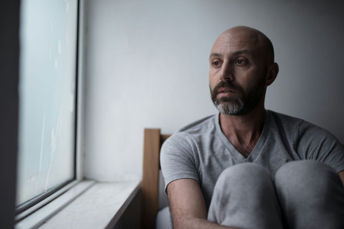 Individual with bipolar disorder reflecting on their mental health journey and exploring new treatment options.
