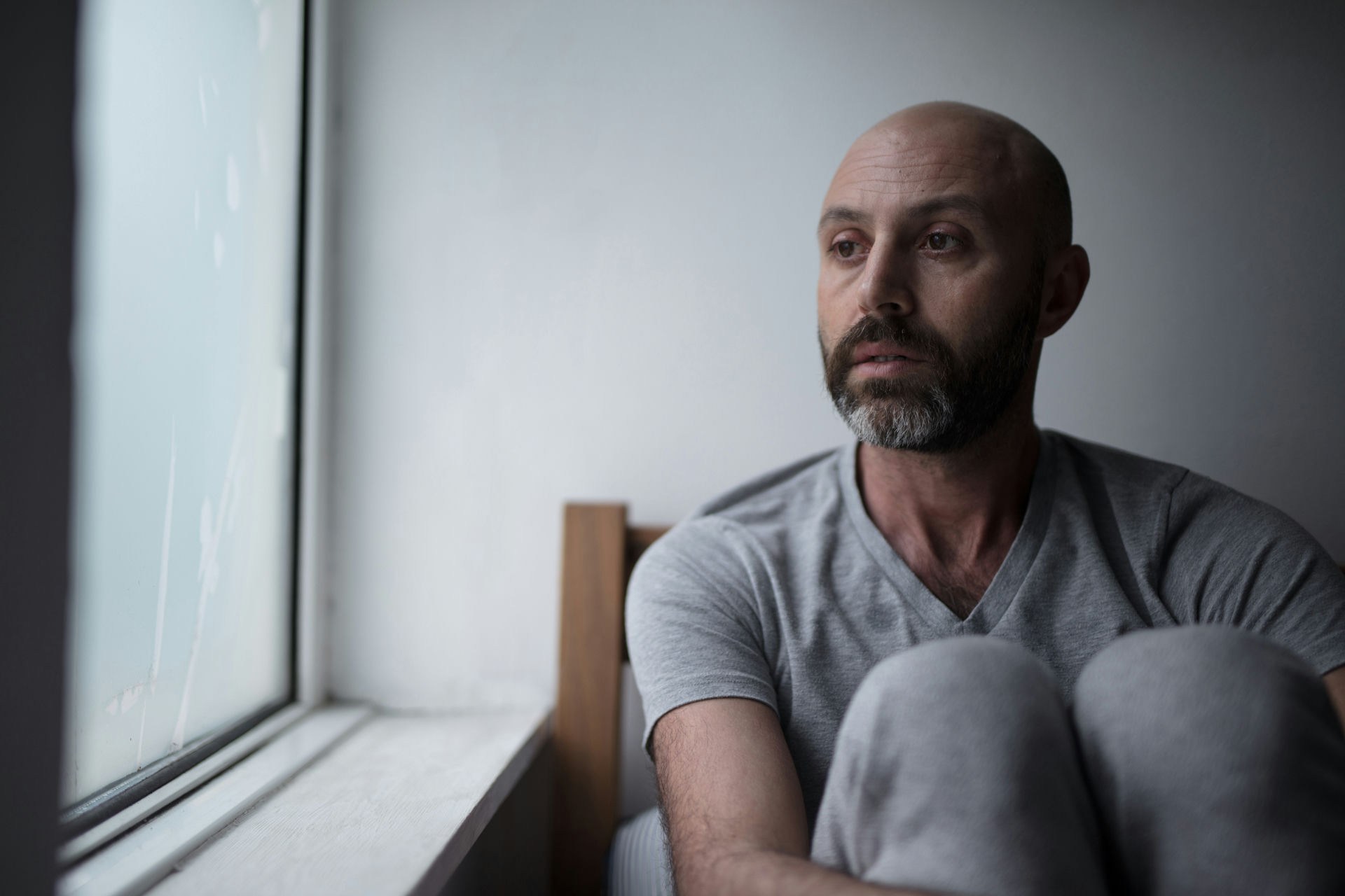 Individual with bipolar disorder reflecting on their mental health journey and exploring new treatment options.