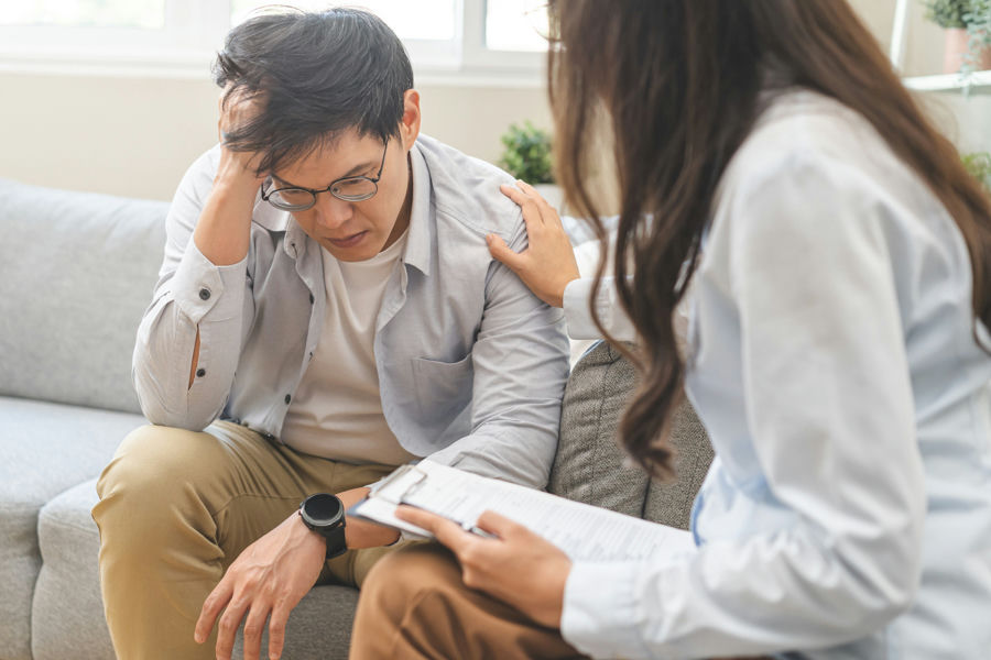 Mental health professional discussing treatment options with a patient in a supportive environment.