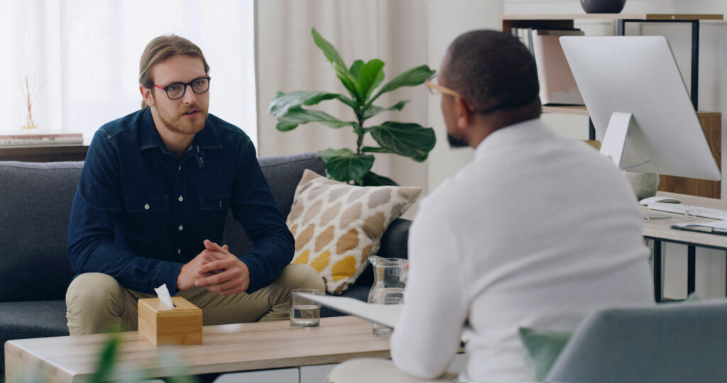 man in therapy speaking with therapist about mood disturbances