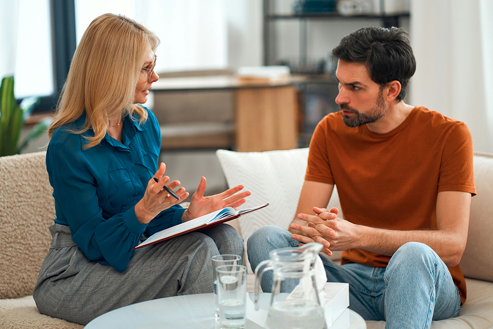 man speaking to therapist about strategies for eating disorder treatment