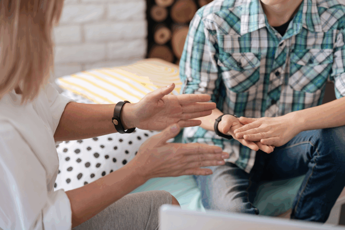 signs you need a trauma therapist, client sitting across from therapist