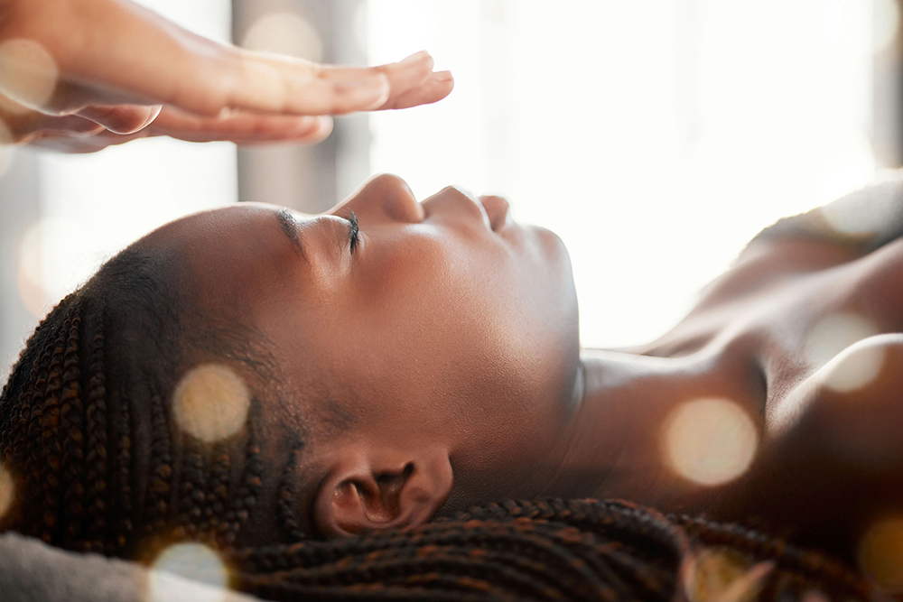 adult receiving reiki therapy to reduce stress and support emotional well-being.