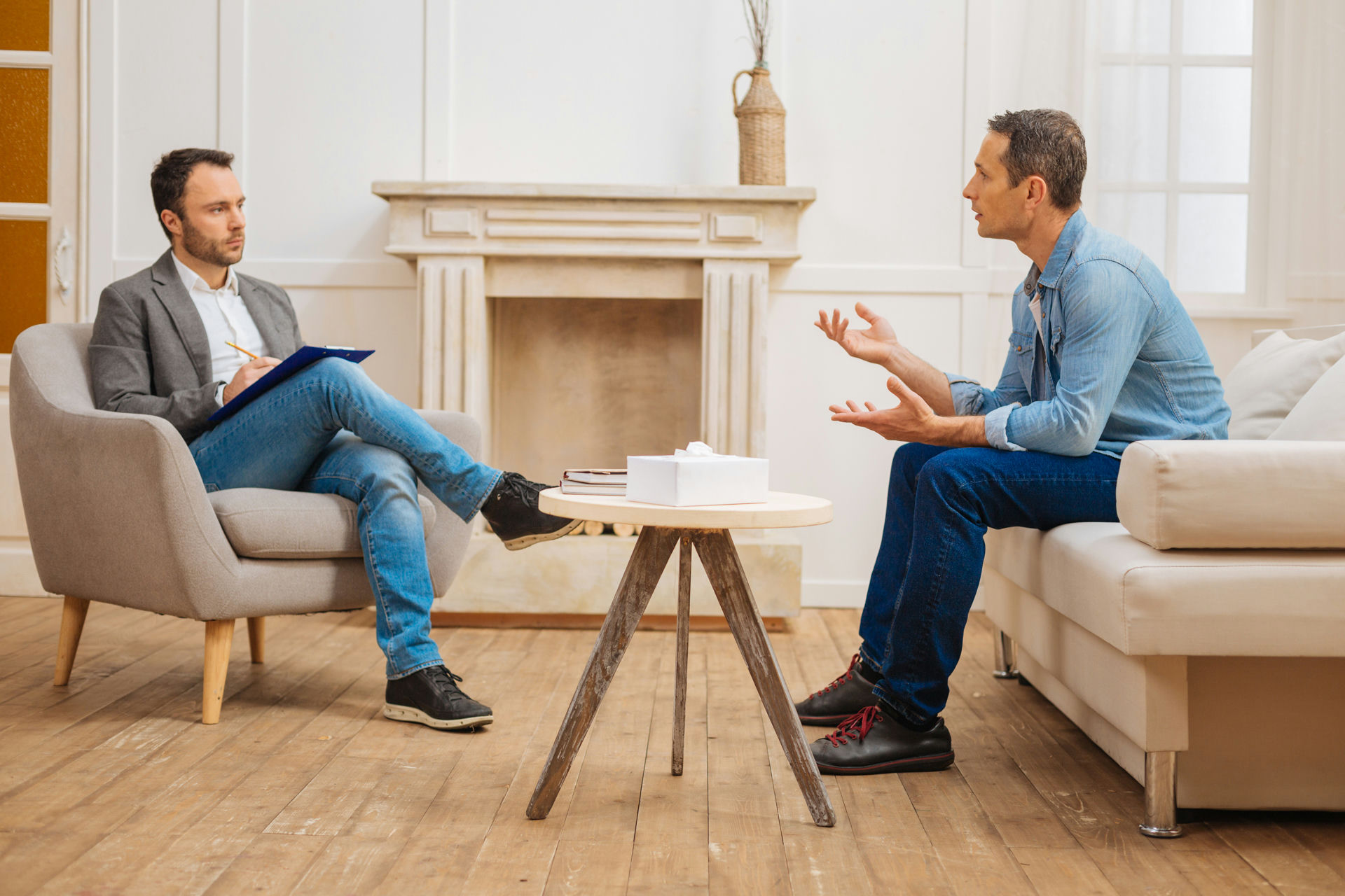 a man talking with a therapist during a mental health evaluation to understand mood disorders vs personality disorders.