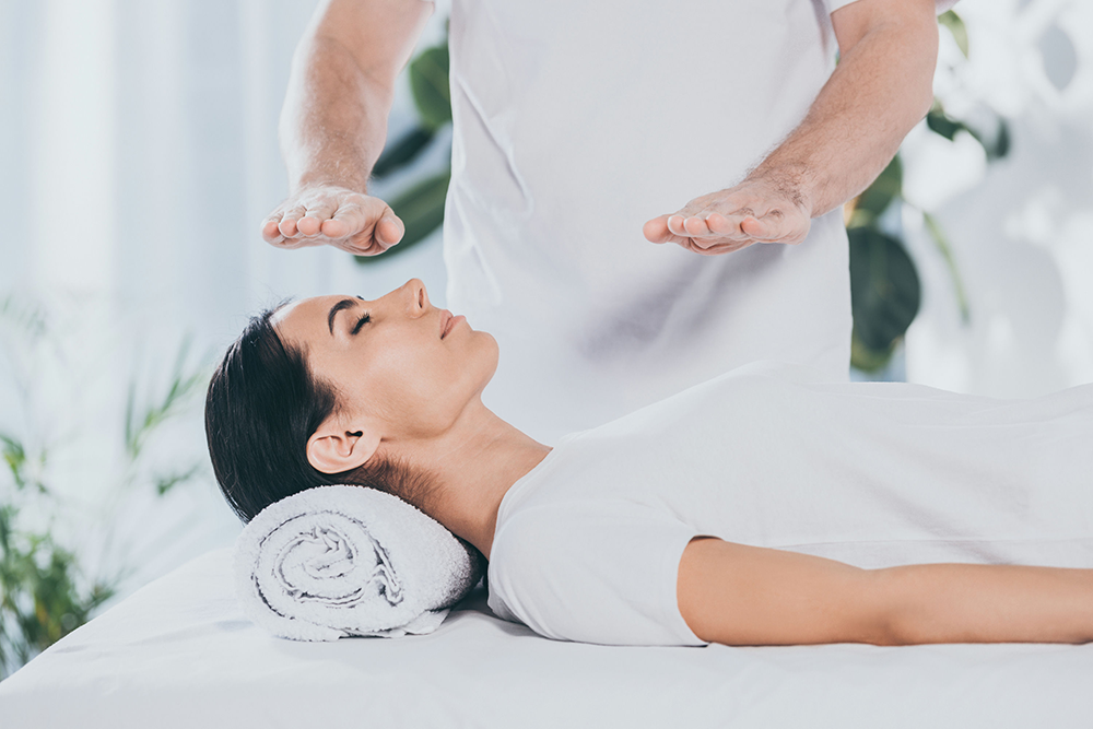 reiki therapy session at a mental health treatment center in New Jersey with a practitioner using gentle hand placements.
