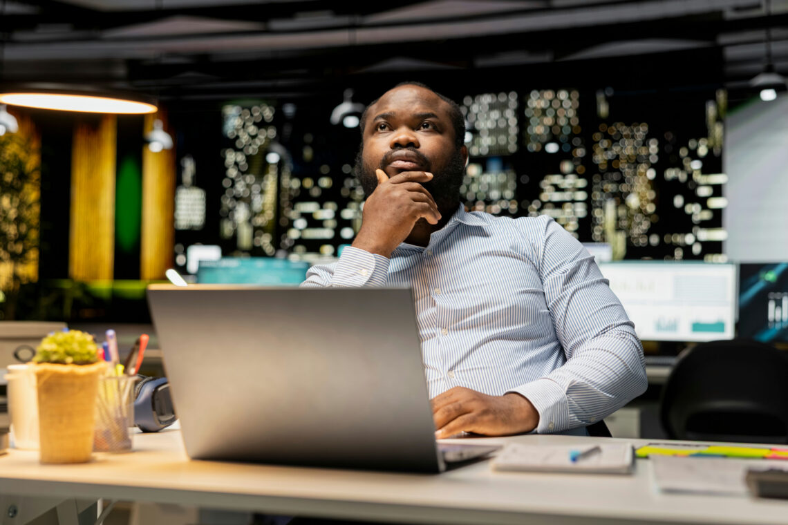 man at work overwhelmed by choices and information, illustrating analysis paralysis and overthinking