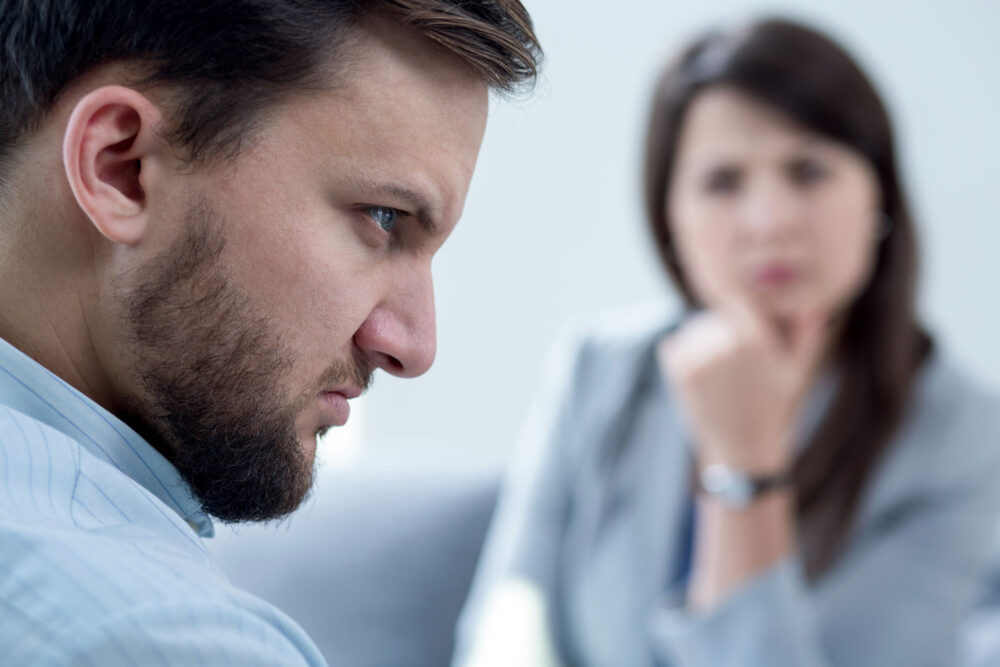 angry man in therapy, approaches used in anger management treatment such as CBT, DBT, and family therapy