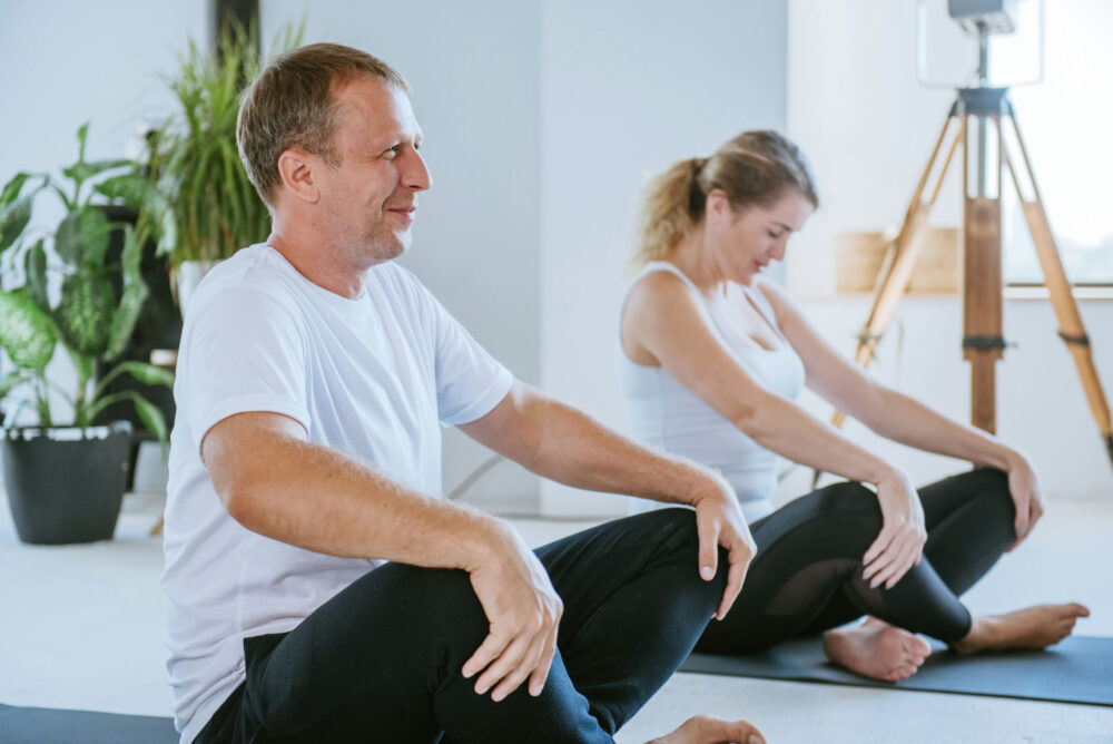 Therapist leading a client through gentle yoga poses during a mental health counseling session in New Jersey