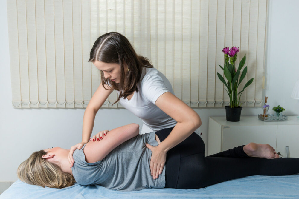 Patient receiving chiropractic adjustment as part of a holistic mental health and wellness treatment plan.