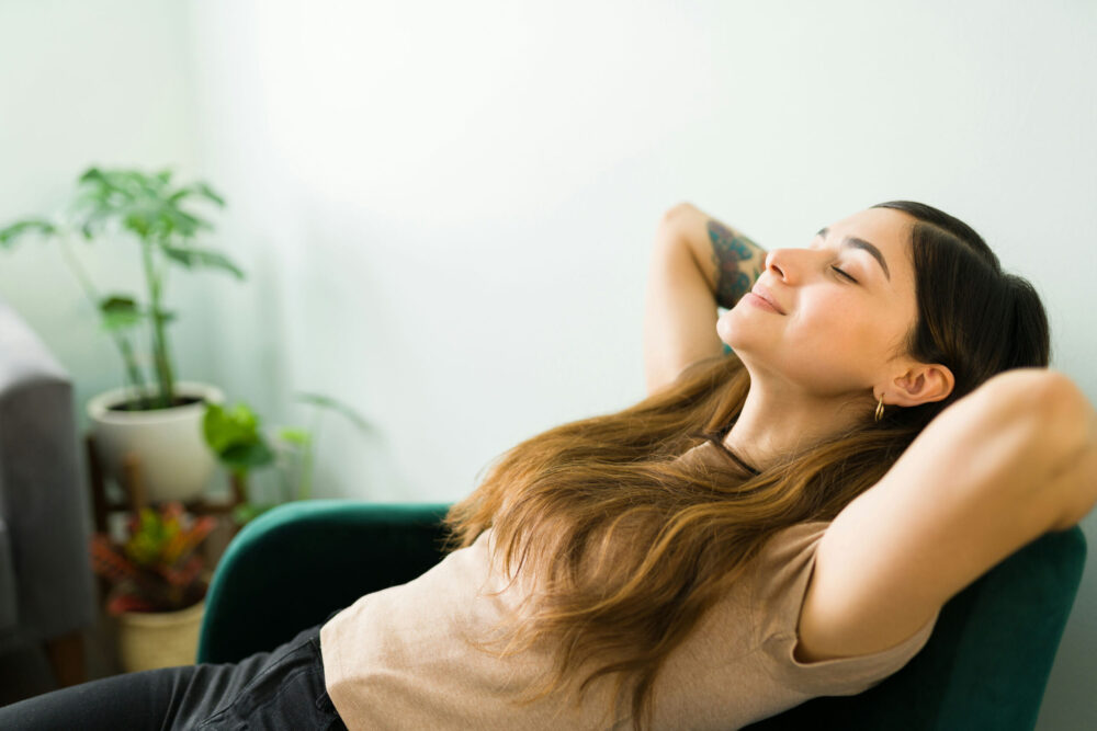 Person using mindful breathing techniques to reduce stress and calm the nervous system